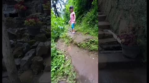 little girl trying to climb rocks