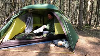 opening the tent from the inside in the woodland