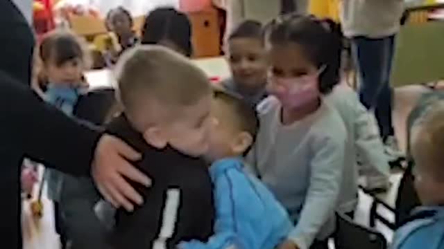 Beautiful moment little Ukrainian boy is hugged by his new classmates