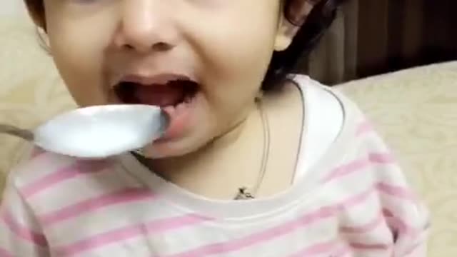 Baby girl wrinkles her nose at the food but wants more!