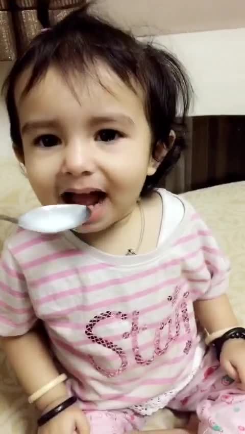 Baby girl wrinkles her nose at the food but wants more!