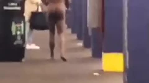 Entirely naked man walks through subway station