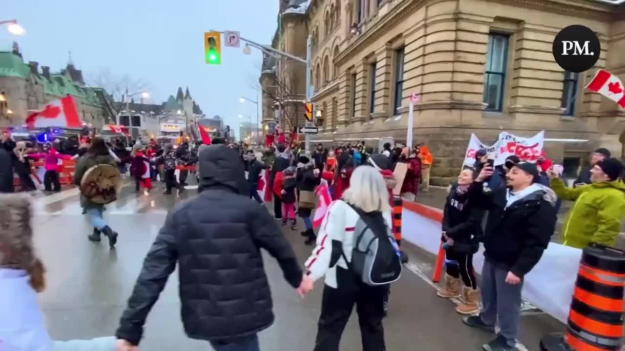 Supporters of the Freedom Convoy hold hands and sing “We Are the World”!!