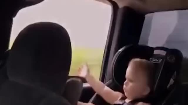 Baby sitting in car seat throws sandal out of window 👶😂