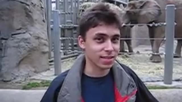 the man is talking at the zoo