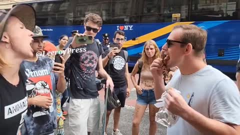 new-york-vegan-demo-man-eats-meat