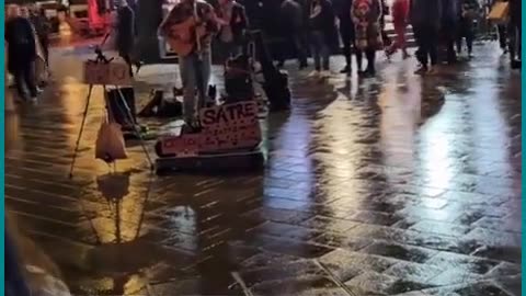 Busker on the streets of London with a song that tells it as it is..