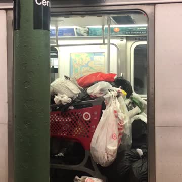 Target cart full of trash bags on subway car