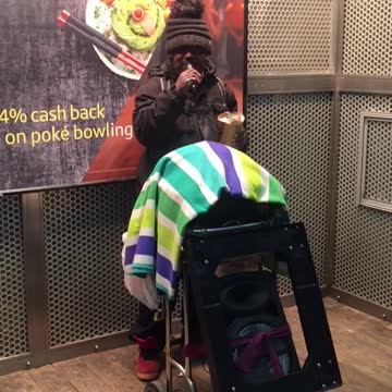 Man playing music green blue towel on wheel chair