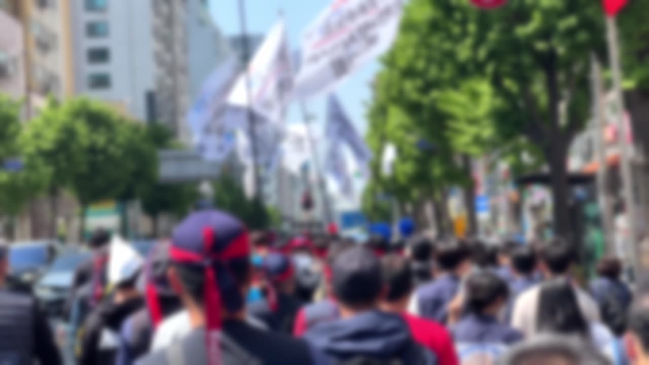 Workers march in protest with flags in Seoul