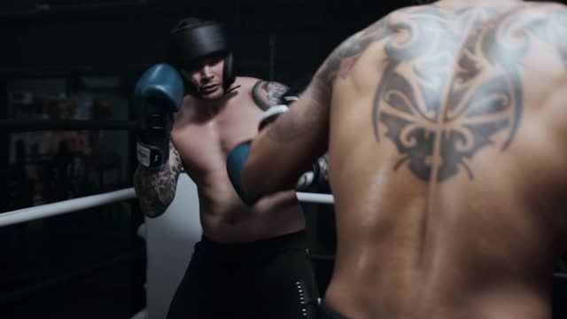 Two men Spars in a boxin