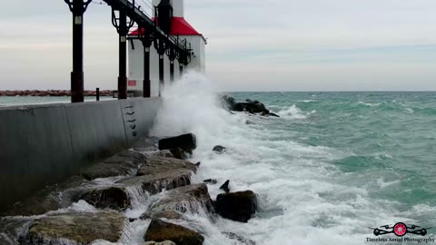 Waves Crashing Over Michigan City Lighthouse & Pier 4K Drone Footage