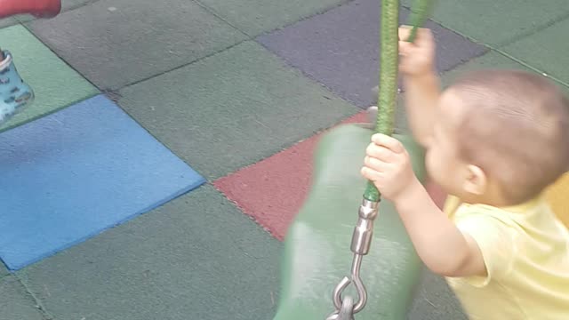 The child is playing on the swing.
