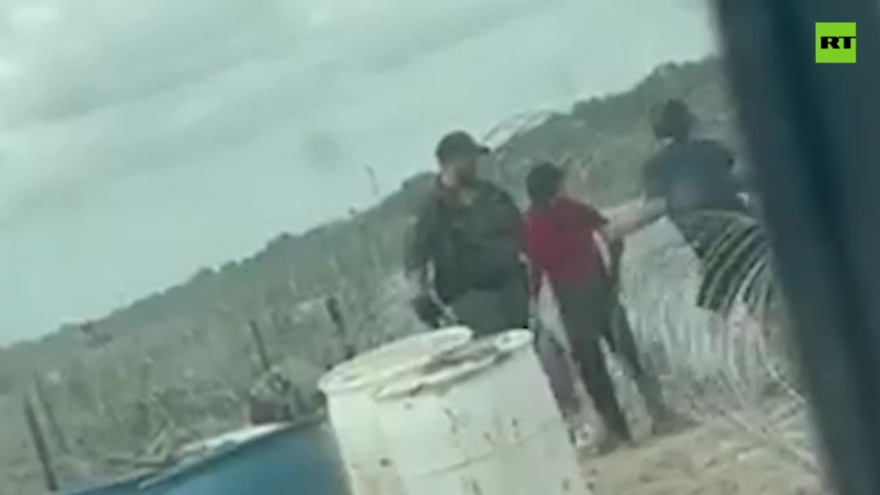 Border agent filmed destroying fence to allow migrants in