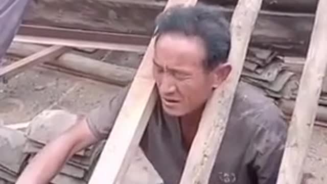 Stupid carpenter accidentally stuck his head between two wooden slats