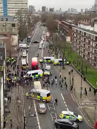 Tension erupts in London as groups with clubs confront law enforcement officers.