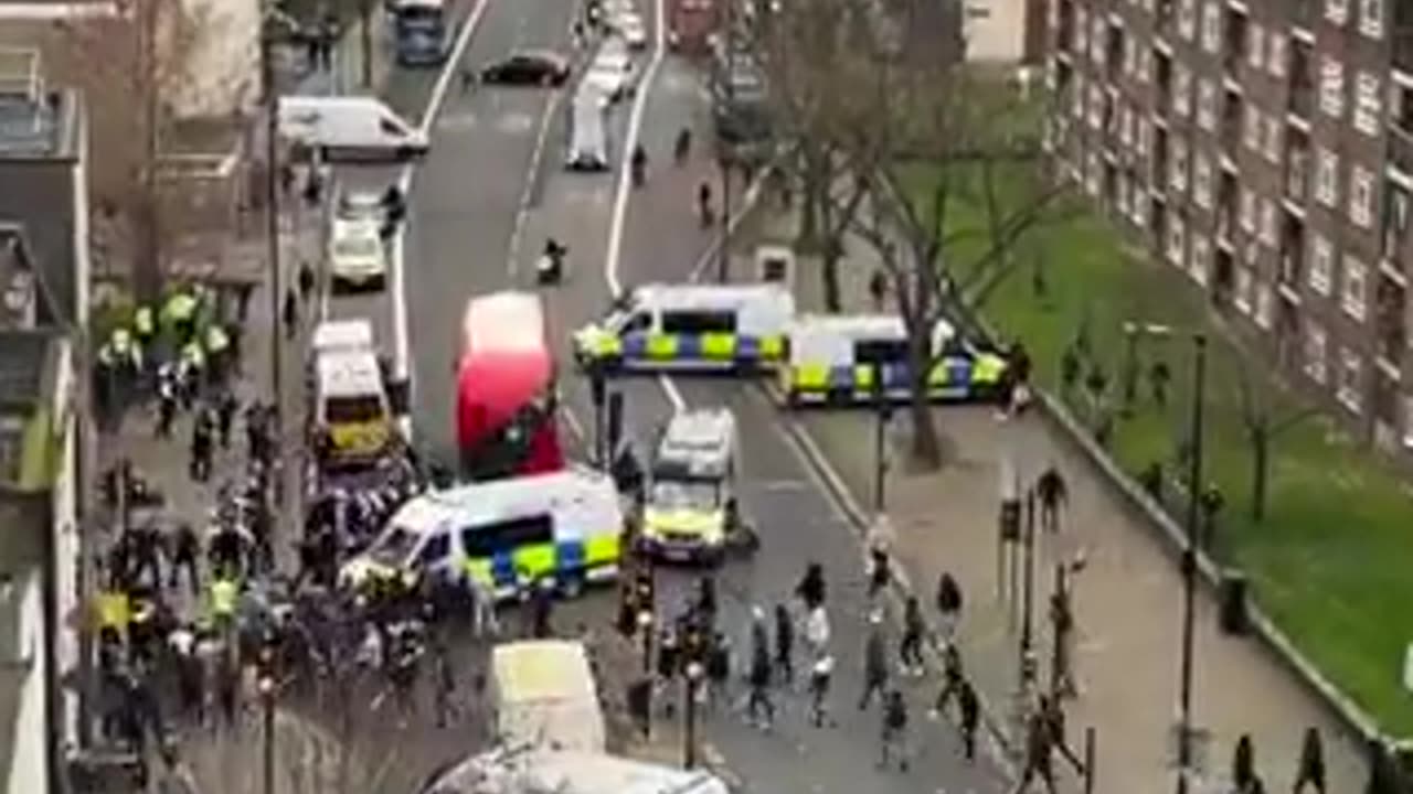 Tension erupts in London as groups with clubs confront law enforcement officers.