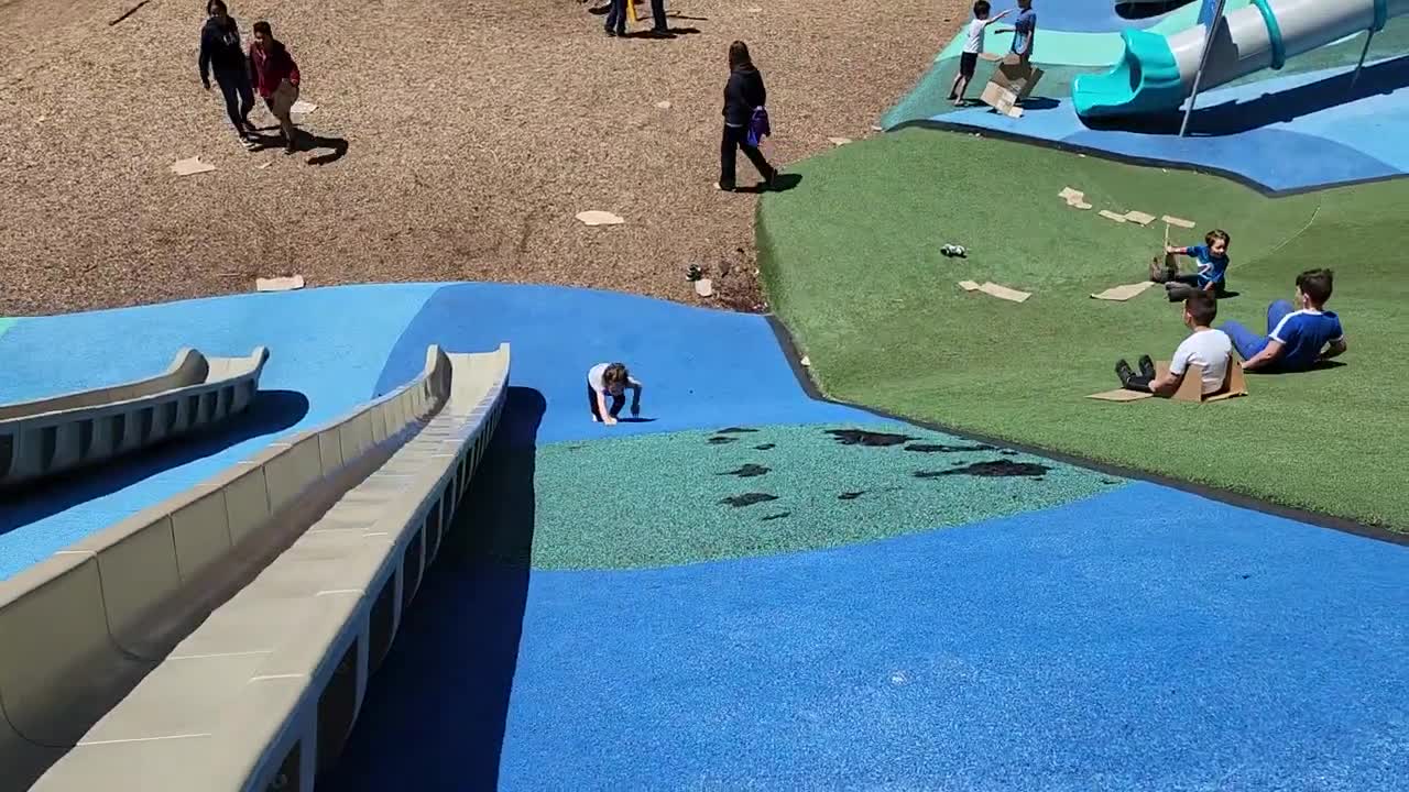Toddler Goes Down a Slide and Faceplants Then Gets Ready to Do It Again