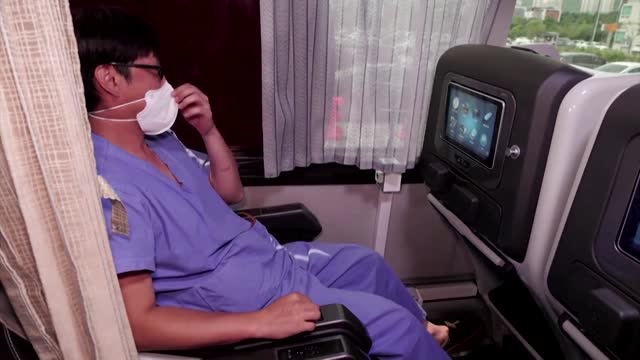 S.Korean health workers cool off in 'recovery buses'