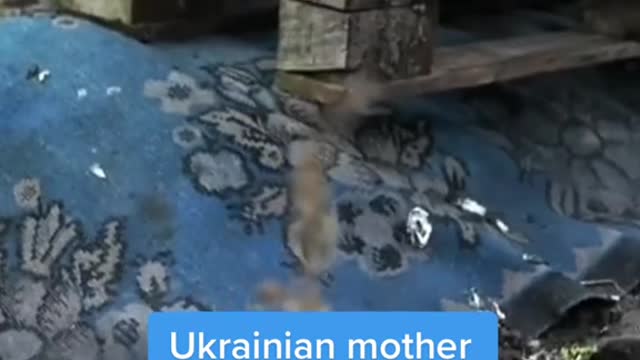 Ukrainian mother buries son herself