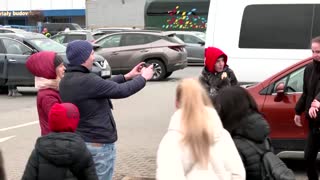 Girl embraces friend who fled Russian invasion