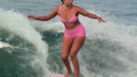 chick riding a long board like a boss