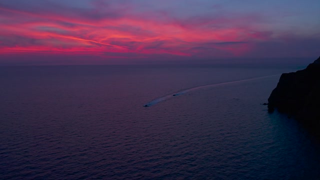 Watercrafts Traveling Under Pink Sky