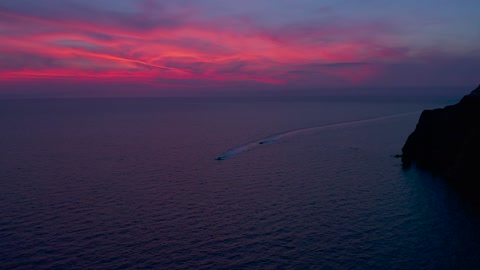 Watercrafts Traveling Under Pink Sky