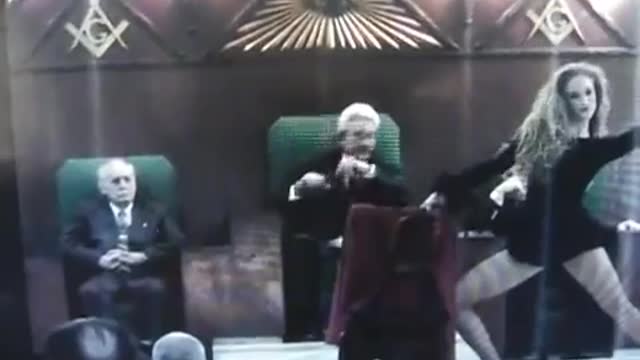 Woman performing a ritualistic dance in front of three grandmasters.