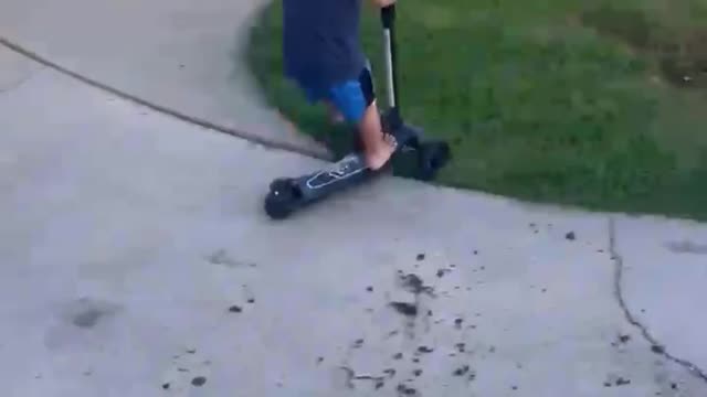 Funny Little Boy Riding Scooter