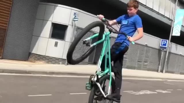 Boy showing his best skill while cycling