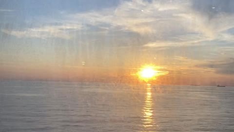 Sunset View Behind the Window of a Ferry