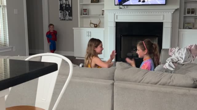 Girl's Hand Clapping Game Distracts from Spider-Man