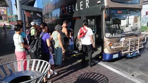 People taking the bus on the Las Vegas strip.