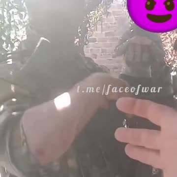 A Russian soldier demonstrates the capabilities of his arm attachment.