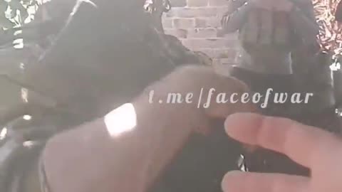 A Russian soldier demonstrates the capabilities of his arm attachment.
