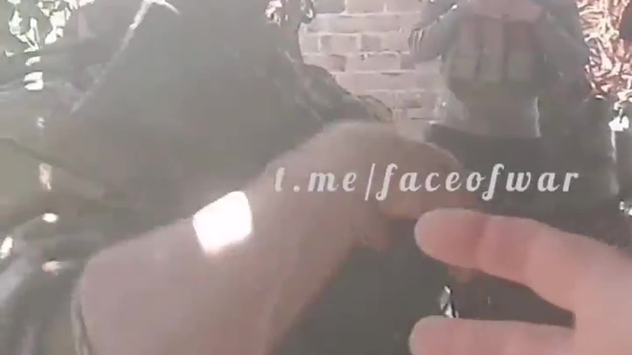 A Russian soldier demonstrates the capabilities of his arm attachment.