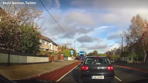 Double-decker bus drives on pavement to overtake queue of traffic