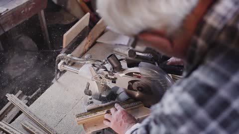 Old Aged Worker with a Circular Saw