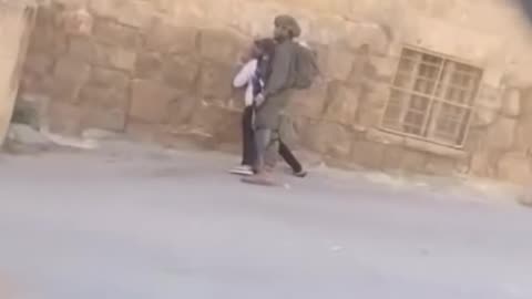 The occupation soldiers are attacking a young man with special needs