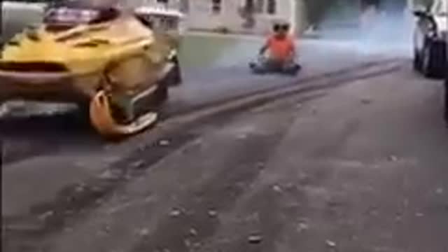 Guy Attempting to Ride Snowmobile on Concrete Road Falls on his But
