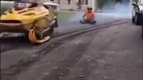 Guy Attempting to Ride Snowmobile on Concrete Road Falls on his But