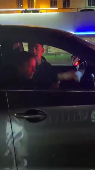 A couple drives past a group of Jews in Beverly Hills, California protesting against Hamas.