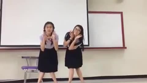 School girls funny dance infront of class