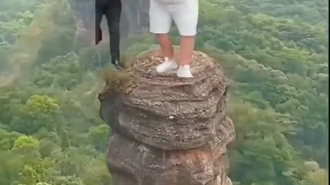 Fat guy dancing on big rock