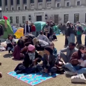 Rep. Ilhan Omar shakes hands with Khymani James