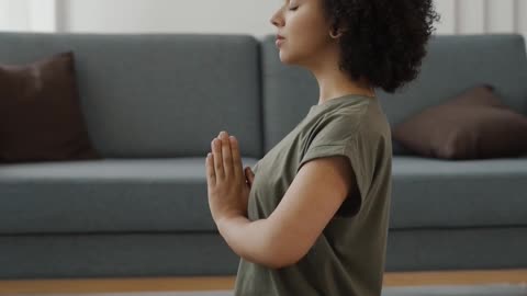 A Woman Meditating In Lotus Position