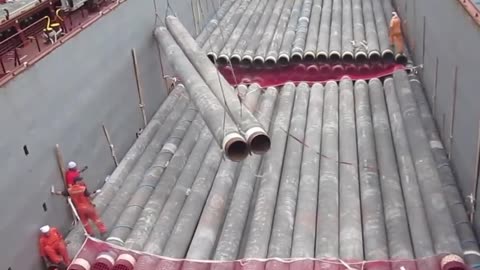 Dangerous loading of pipes on a ship in a storm