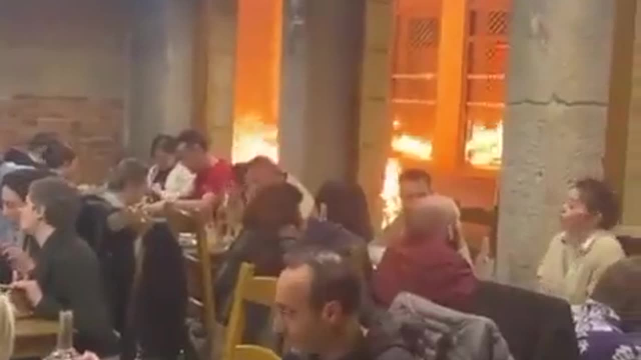 France: Parisians eating while Paris burns.. bizarre!