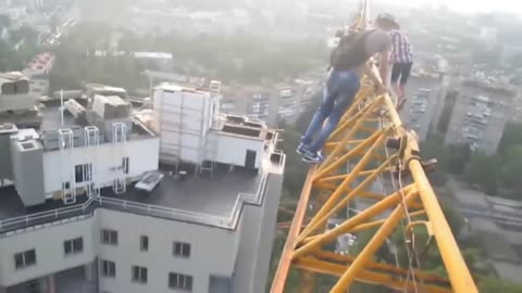 Kid's doing stupid S#it on a tall crane